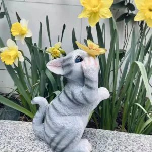 cat statue with butterfly on nose