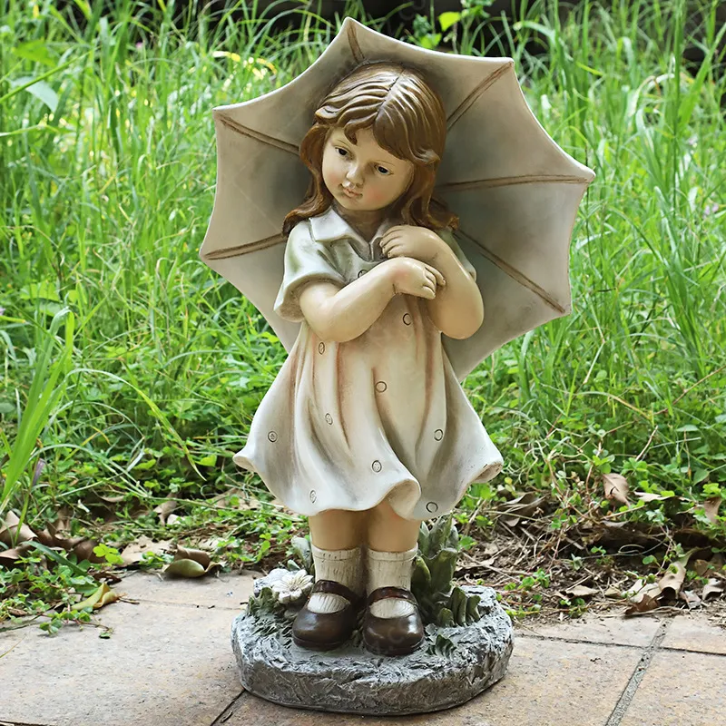 boy and girl with umbrella statue