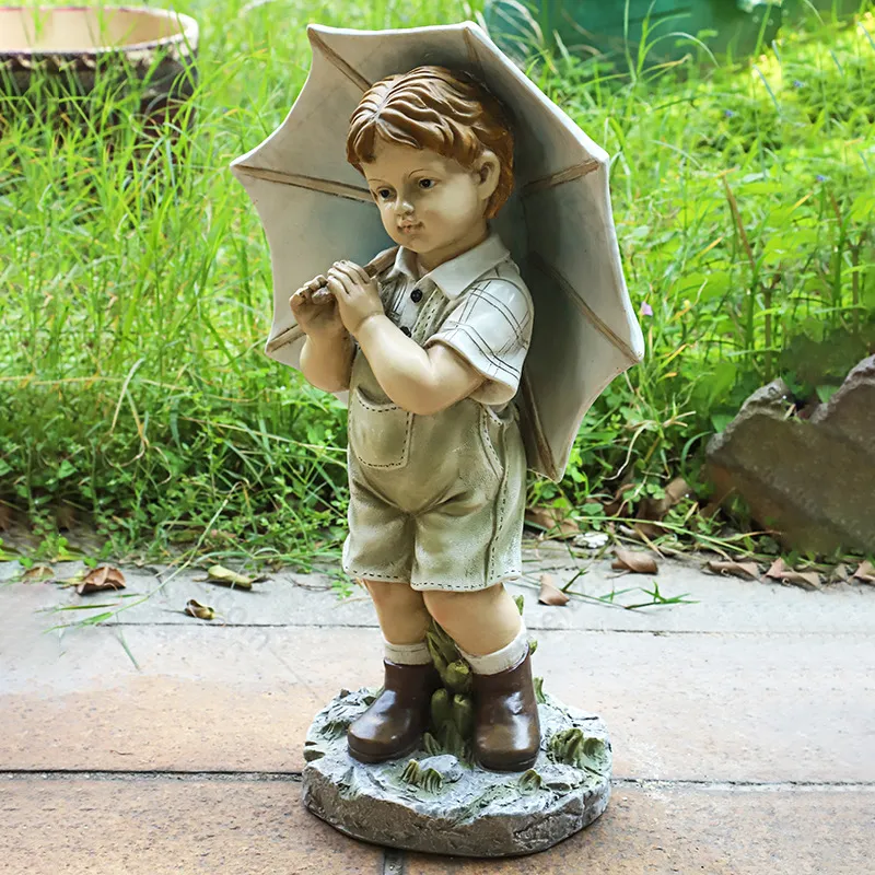 boy and girl with umbrella statue