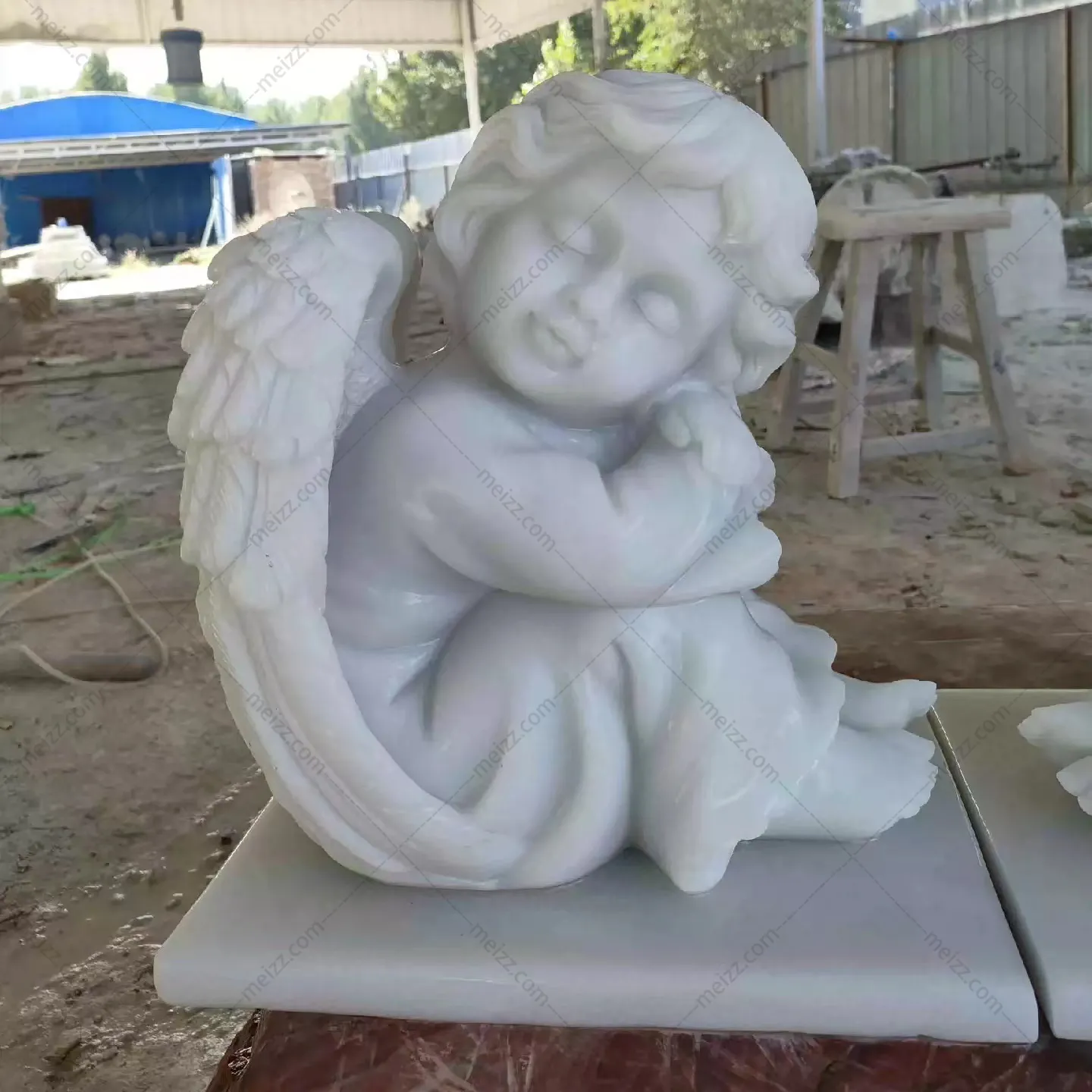 sleeping cherub garden statue